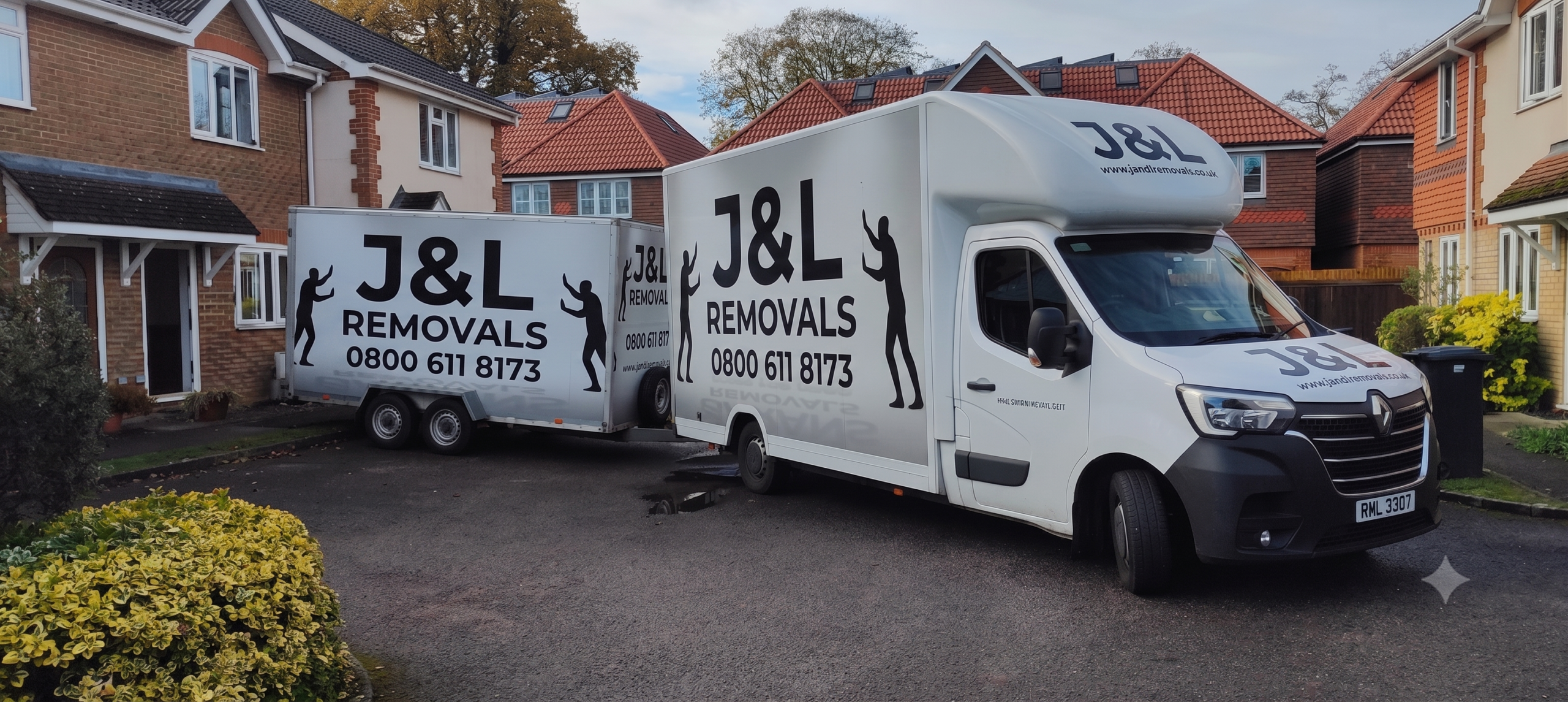 J&L Removals van loading furniture outside a local home